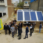 Industry experts and dignitaries at a solar panel demonstration in India — Su-Kam 3-phase solar system launch